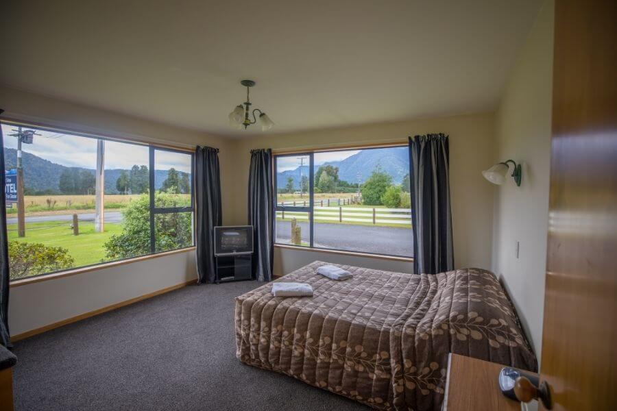 bedroom with tv and views of mountains