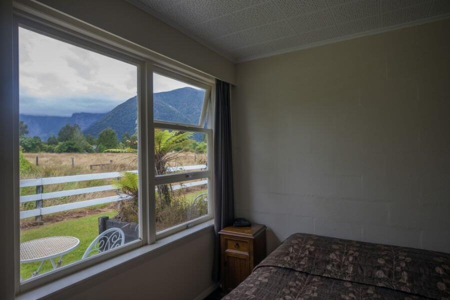 Cottage bedroom views of Southern Alp mountains through window